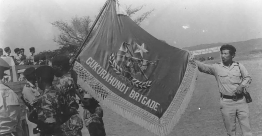 The flag of the Zimbabwean National Army’s 5th Brigade, Gukurahundi, after its presentation to Col. Perrance Shiri, its commander in 1982. / National Archives of Zimbabwe